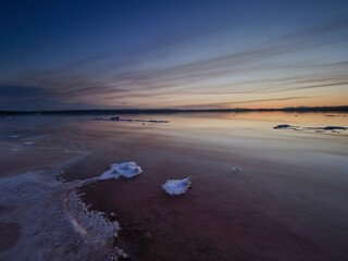 Fototapeta premium Sunset on the pink lagoon of the salt flats of Torrevieja, Spain