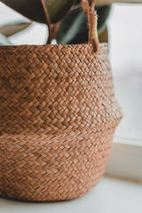 Detail of a wicker basket with a lid with natural light, sunlight and shade. Original weaving from corn fiber.