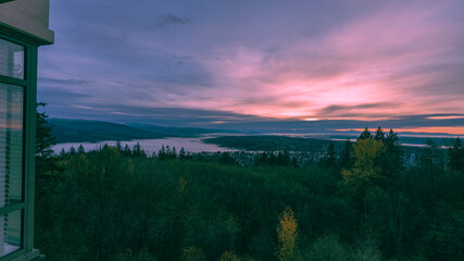 sunrise over the valley with cloud inversion and mountains on horizon in silhouette