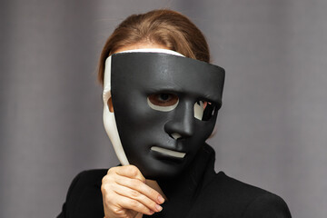 split personality,psychology and psychiatry,bipolar mental disorder,paranoia,psychiatric diseases, woman with black and white masks on her face