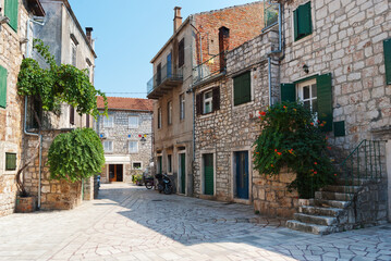 Fototapeta na wymiar Street view, sity of Stari Grad on Hvar Island, Croatia, mediterranean architecture, plants and flowers