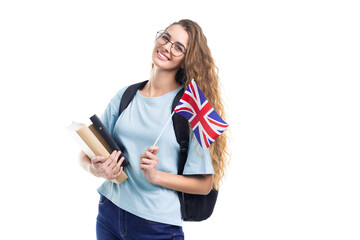 Young student woman in glasses holds an United Kingdom flag and books isolated on white background