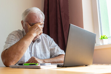 senior old man male sit desk, home office online notebook laptop work distance freelancer tired...