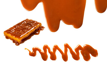 Background of flowing caramel sauce isolated on white.