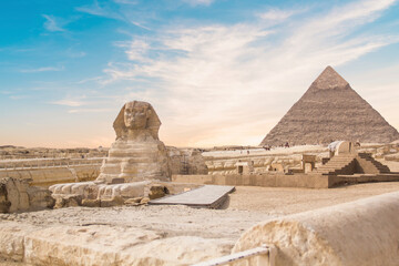 Great Sphinx against the background of the pyramids of the pharaohs Cheops, Khafren, and Mikerin in Giza, Egypt