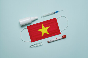 Blood tube for test detection of virus Covid-19 Omicron Variant with positive result, medicine mask with Vietnam flag superimposed and vaccine.  New Variant of the Covid-19 Omicron - 475727094