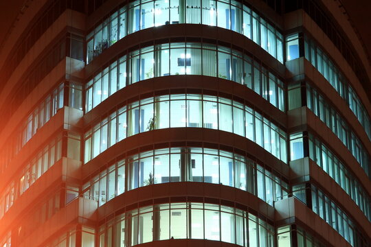 The Facade Of A Round Glass Building With Large Panoramic Windows And Balconies At Night, The Windows Glow In Dark. Dnipro City, Dnepr, Ukraine