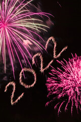 Happy New Year 2022. Sparkling burning numbers Year 2022 with firework on black background.