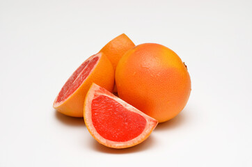 Naklejka na ściany i meble fresh juicy grapefruit in a cut close-up on a light background