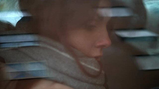 sadness, depression - unhappy woman locked alone in the car with catatonic look