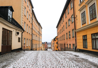 Traditional Swedish cobblestone street in Södermalm, Stockholm, Sweden, on a snowy winters day.