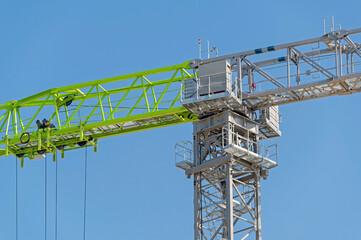 Naklejka premium construction crane at blue sky as background
