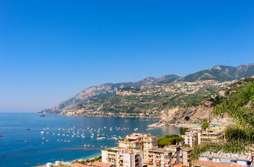 View of the sunny scenic coastline, harbour, boats and sea off of Maiori, Amalfi coast, Italy.