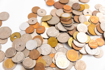 Many kind of coin country pile up on white background.