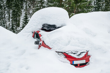 a red car covered in snow