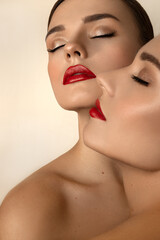 two girls with closed eyes and red lips with closed eyes strapless