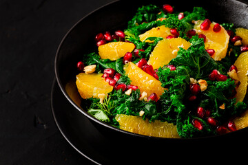 Kale cabbage salad with orange and pomegranate seeds, healthy food, top view, no people,