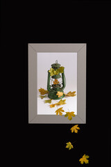 Autumn creative concept. The leaves fall out of the photo. Isolated on a black background.
