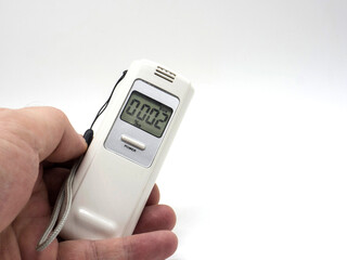 Modern breathalyzer and mouthpieces on white background