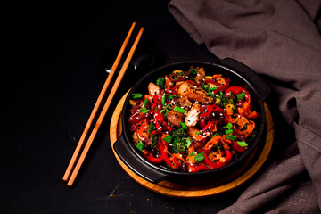Asian cuisine, teriyaki meat with vegetables, in a cast-iron frying pan, close-up, no people,