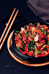 Asian cuisine, teriyaki meat with vegetables, in a cast-iron frying pan, close-up, no people,