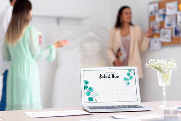 Laptop with Save the Date Announcement on screen in wedding planner's office