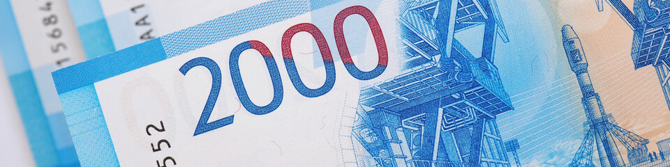 Russian banknotes 2000 rubles close-up. Money on a banner on the theme of banking economy and taxes...