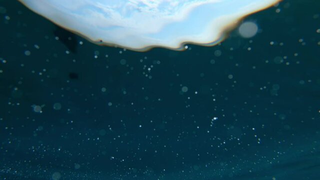 Ocean surface from below, camera sunken underwater