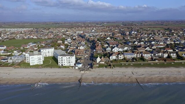 Aerial along the seafront of East Wittering, a seaside village in Southern England and popular with tourists in the summer.