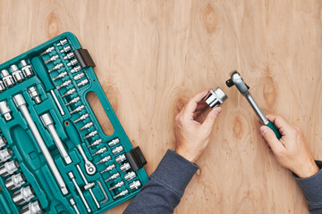 Man working in workshop using many tools. Wrench, spanner, calliper and ratchet with many...