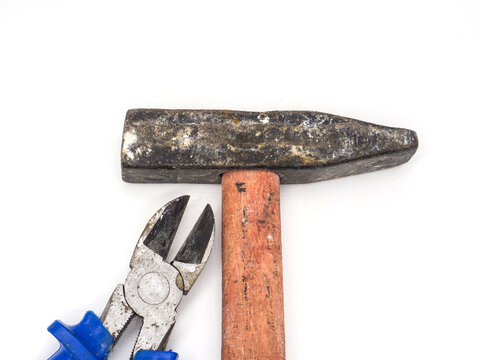 Old Rusty Hammer And Wire Cutters On White Background