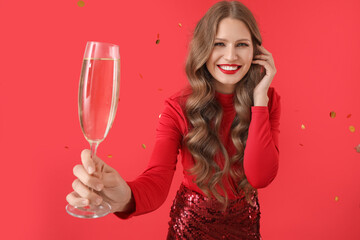 Beautiful young woman with champagne and falling confetti on color background