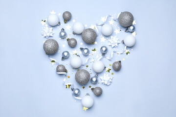 Heart made of Christmas decor on light background