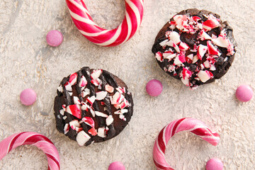 Tasty candy cane cookies on light background