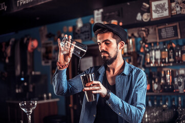 Barman makes a cocktail in the bar