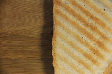 Bread sandwich from the top on a wooden background.