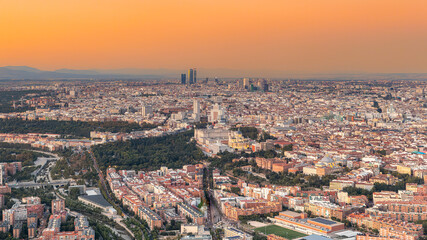 Aerial views of the city of Madrid during sunset on a clear day, being able to observe the five...