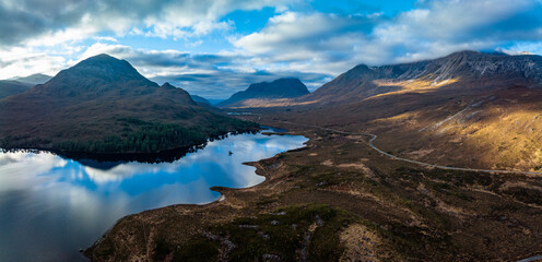 Naklejka na ściany i meble an aerial view of the torridon mountains near liathach, beinn eighe and sgurr dubh in the north west highlands of scotland during winter