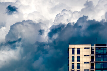 Beautiful view of a high rise building with storm clouds in the background in Klaipeda, Lithuania © Ruslan Bolgov/Wirestock