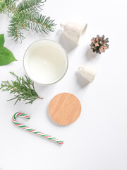 Candle, pine cones, candy, white bells, wooden details, green leave and fir branch on the white background. Xmas set.