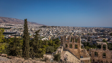 Fototapeta na wymiar Showing a small part of The Theatre of Herodeon Atticus or Odeon of Herodes Atticus or Herodeon with a panoramic view of Athens in Greece.