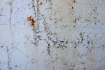 Rusty metal wall painted with paint. Rusty metal background with streaks of rust.