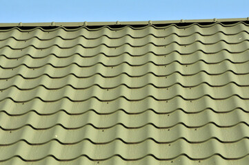 The roof of the house is covered with metal tiles