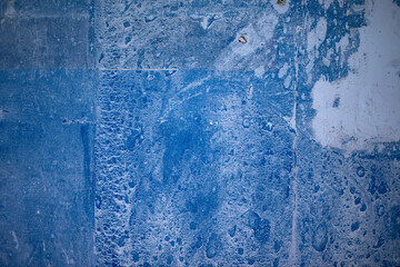 Blue paint on concrete walls covered with plaster.