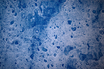 Blue paint on concrete walls covered with plaster.