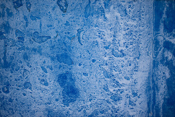Fototapeta na wymiar Blue paint on concrete walls covered with plaster.