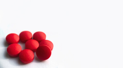 Selective focus, group of red medical pills isolated on white background.Health and medicine concept