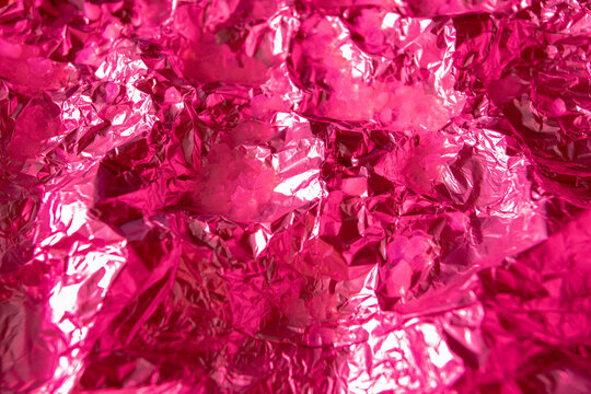 Pink Design Background Made Of Silver Foil Lit By Holographic Neon Pink Color.