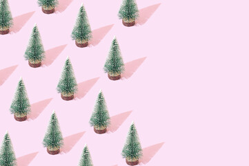 A pattern made of snowy Christmas Trees on a pastel purple background. Minimal New Year aesthetic violet composition with copy space