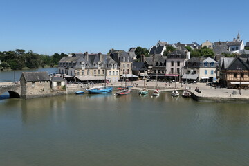 Fototapeta na wymiar Fairytale beautiful ancient village in Brittany and a green river and canoe port.